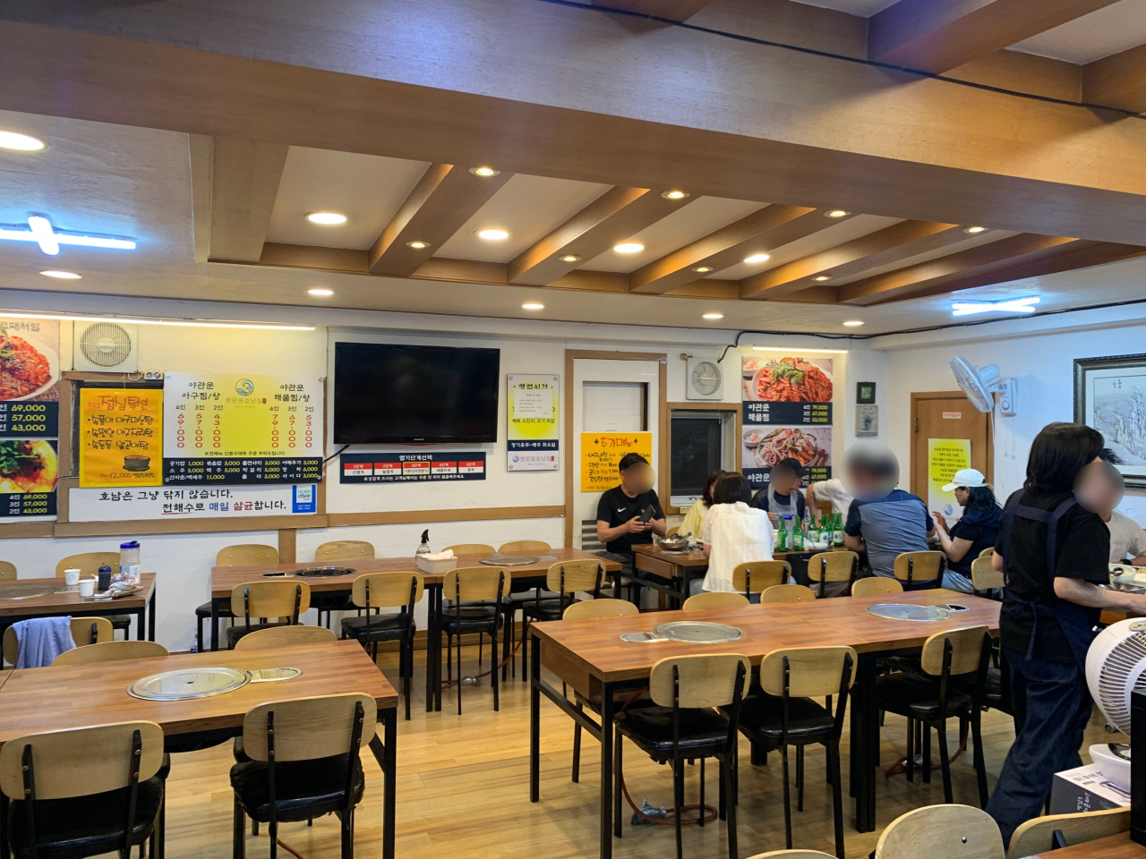 Dining room with menu boards and customers
